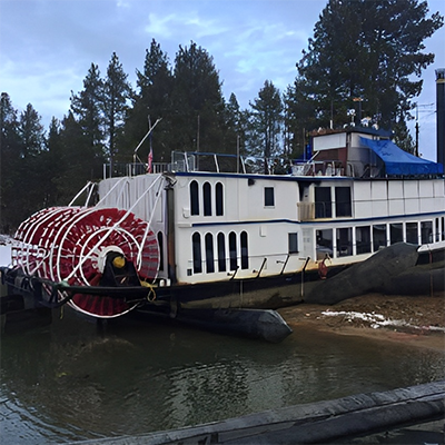A paddle steamer pulled up onto shore